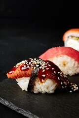 sushi on a wooden board on a black textured background