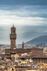 Fototapeta na wymiar Tower of the Palazzo Vecchio in Florence in the foreground