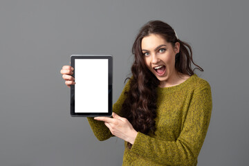 emotional, attractive young woman showing tablet computer with empty touch screen with copy space