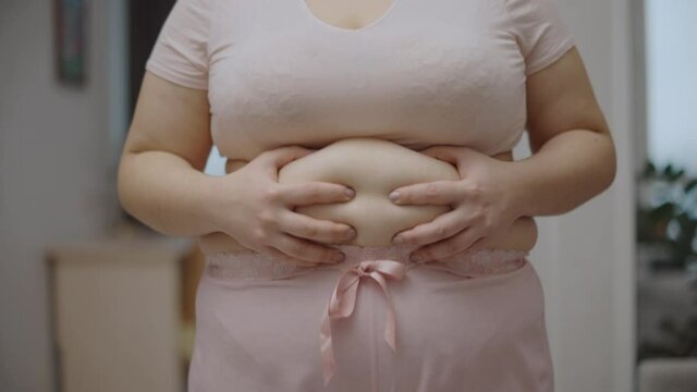 Female suffering from excessive abdominal fat, hormone level, health problem