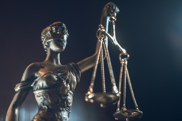 lady justice statue isolated on dark background
