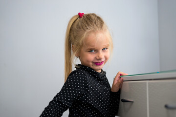 little blonde girl did her own makeup with mom's makeup