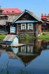 old rusian village with wooden houses on the lake 
