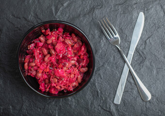Close up photo of homemade Vinaigrette with Beans in black bowl 