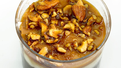 Close-up cocoa cup cake, chocolate pastry cream, caramel sauce and hazelnut croquant.