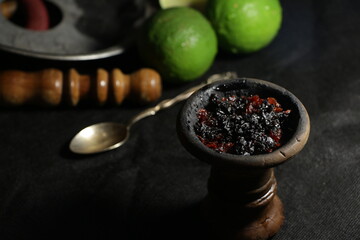 bowl with hookah tobacco. berries on a black background. shisha smoking