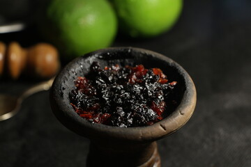 bowl of hookah tobacco. berries on a black background. narghile smoking