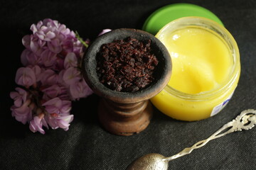 bowl with tobacco for hookah on a dark background. berries on a black table. shisha smoking