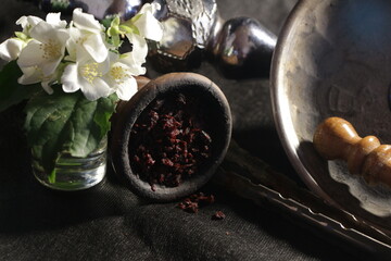 bowl with hookah tobacco. berries on a black background. shisha smoking