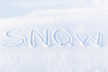 inscription on pure white snow on a frosty winter sunny day. close-up. russia
