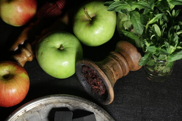 bowl with hookah tobacco. shiisha with fruits on black background.