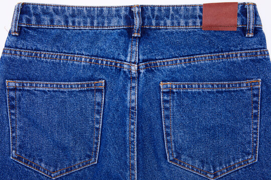 Back of waist blue jeans with two pockets and loops on white background