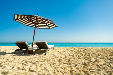 Dream paradise beach with umbrella and chairs at the turquoise Mediterranean sea at El Alamein near Alexandria, Egypt