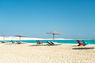 Dream paradise beach with umbrellas and chairs at the turquoise Mediterranean sea at El Alamein...