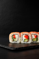 rolls on a black board on a dark textured background