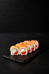 rolls on a black board on a dark textured background