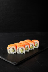 rolls on a black board on a dark textured background