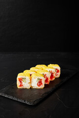 rolls on a black board on a dark textured background