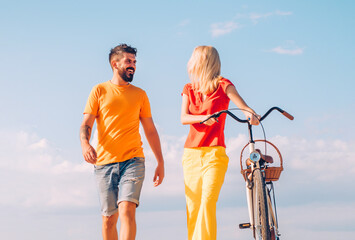 Young couple walk. Walking people. Happy friends on nature outdoor. Leisure and lifestyle concept. Young woman with vintage bike in a country road.