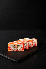 rolls on a black board on a dark textured background