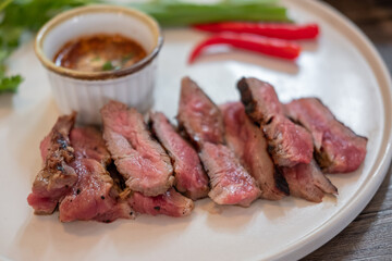 Medium rare meat on plate with sauce