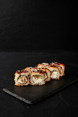 rolls on a black board on a dark textured background