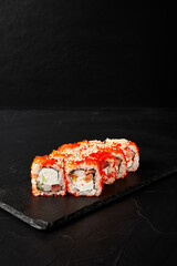 rolls on a black board on a dark textured background