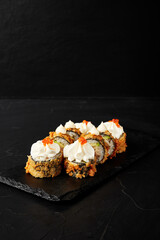 rolls on a black board on a dark textured background