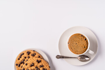 Flat lay black coffee with foam in a white cup and cookies isolated on white background.