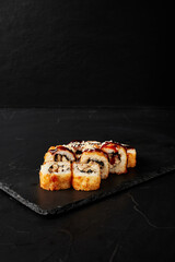 rolls on a black board on a dark textured background