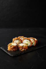 rolls on a black board on a dark textured background