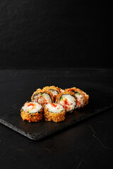 rolls on a black board on a dark textured background