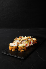 rolls on a black board on a dark textured background