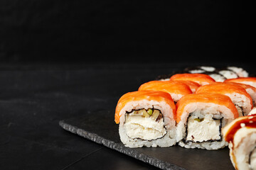 rolls on a black board on a dark textured background