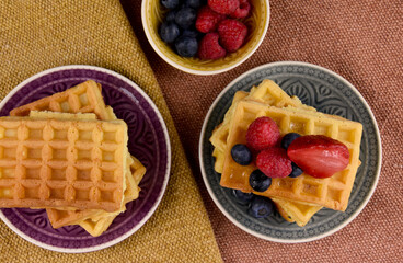 Homemade traditional belgian waffles with fresh fruits berries top view stock images. Fresh waffles with berries on the table photo. Sweet breakfast with waffles and fruit images