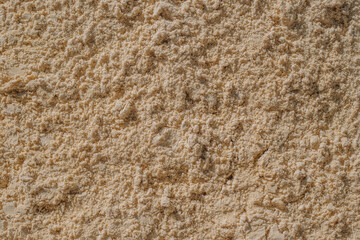 River yellow wet sand. Natural background from many grains of sand, texture, pattern
