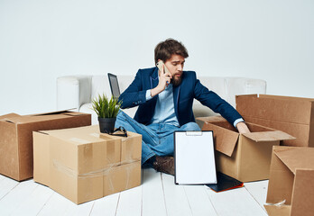 Man talking on the phone boxes with things moving official lifestyle