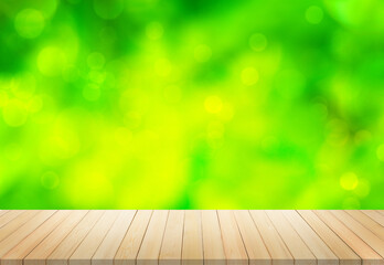 Wooden table in front of blur green natural background