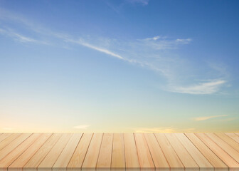 Wooden table in front of  bright blue sky background
