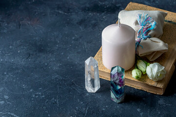 Magic composition with pink candle, crystals, pagan bag and flowers. Esoteric and pagan rituals,...