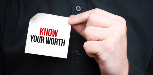 Businessman holding a card with text Know Your Worth,business concept