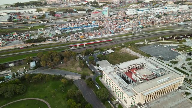 Aerial of a train passing between Faculty of Law and Villa 31 in Buenos Aires, Argentina
