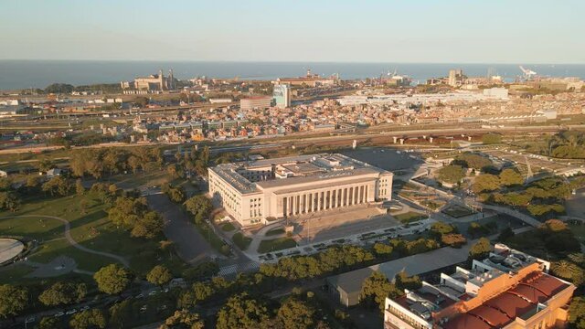 Aerial parallax shot of the Faculty of Law of University of Buenos Aires and Villa 31 on background