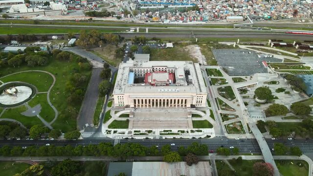 Aerial orbit shot of the Faculty of Law of University of Buenos Aires at dusk. High angle