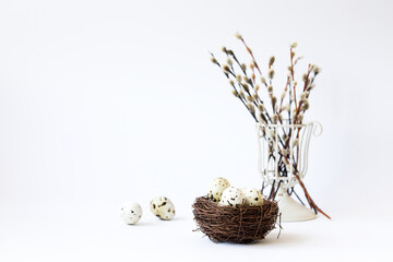 Easter composition. Holiday concept on white willow and quail eggs in the nest. Idea of decoration for the celebration of Happy Easter. © lily_rocha