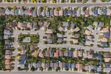 Aerial top down view of houses and streets in beautiful residential neighbourhood during fall season in Calgary, Alberta, Canada.