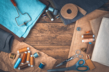 A set of sewing accessories on a wooden background with space to copy.