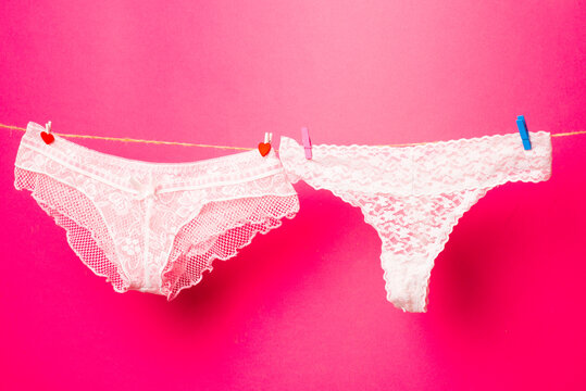 Womans panties on clothesline. Colorful erotic panties. Women's underpants on rope. Pink panties Woman underwear.