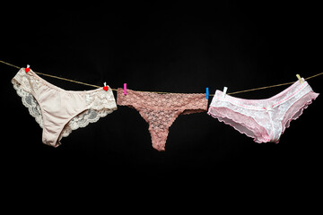Woman underwear. Female lingerie on clothesline. Colorful erotic panties. Women's underpants on rope.