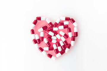 Heart pills on white background.